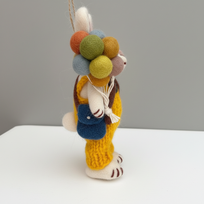 Side view of balloon bunny wool felt pendant - handcrafted ornament charm in overalls
