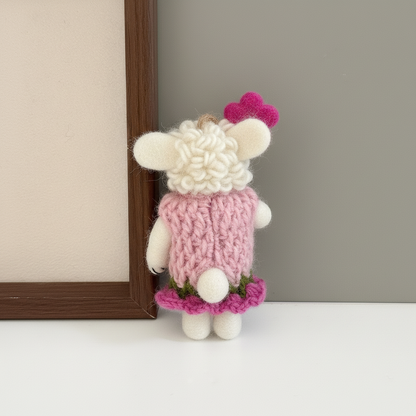 Back view of handmade wool felt lamb charm showing blush pink felt construction
